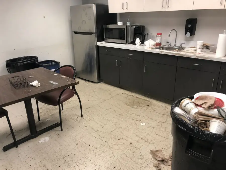 Office break room before cleaning — cluttered counters and full trash